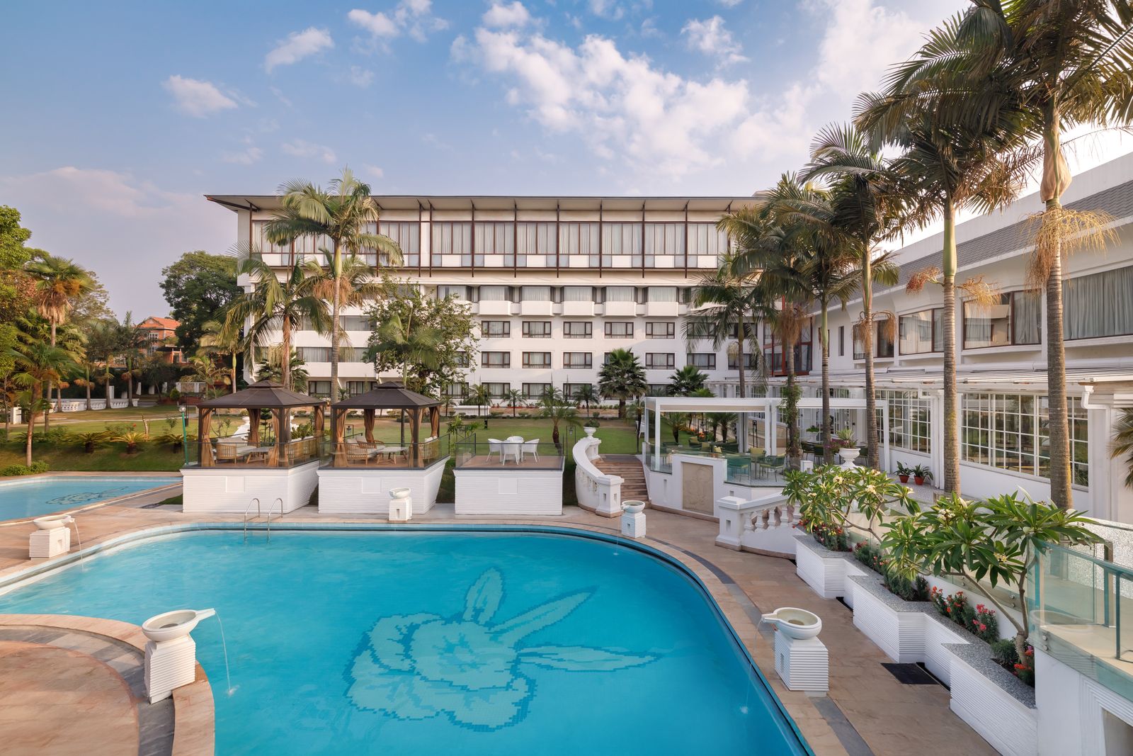 Hotel Himalaya exterior and swimming pool surrounded by gardens